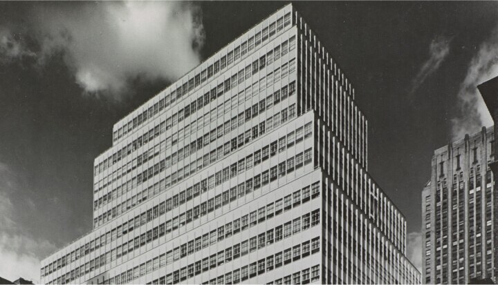 Black and white photo of the Colgate headquarters building from the 1950s